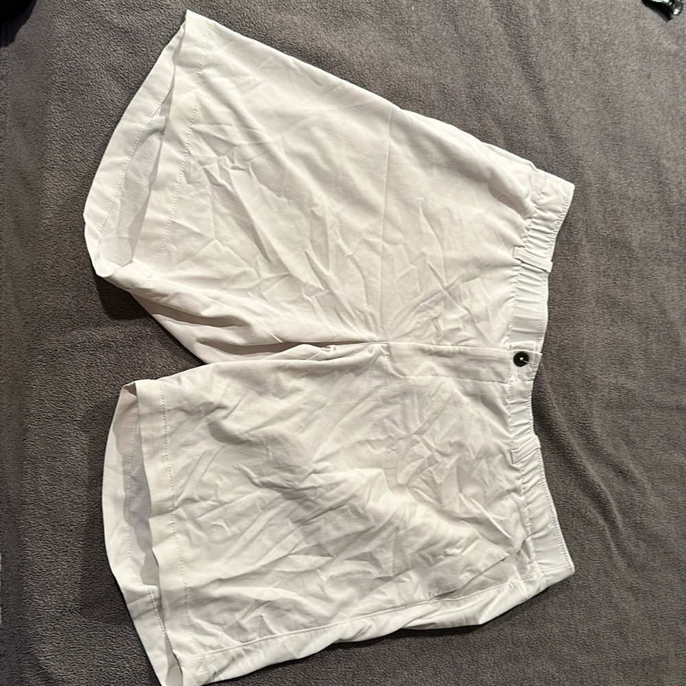 White pair of Under Armour golf alshorts